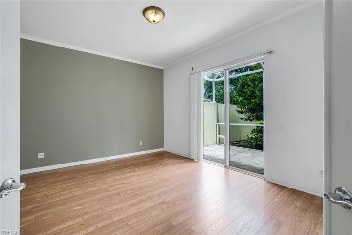 Spare room featuring ornamental molding and light hardwood / wood-style floors