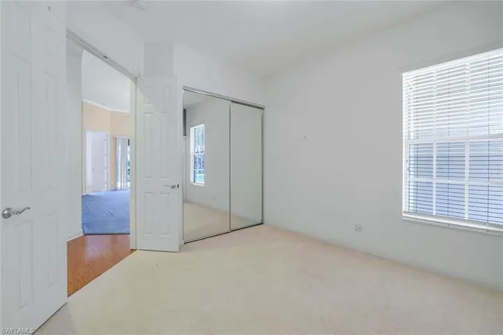 Unfurnished bedroom featuring a closet and carpet flooring