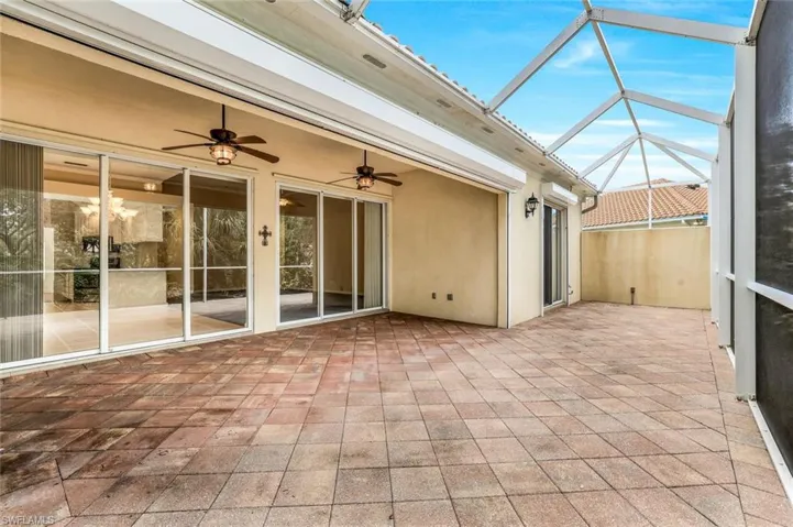 Unfurnished sunroom with ceiling fan