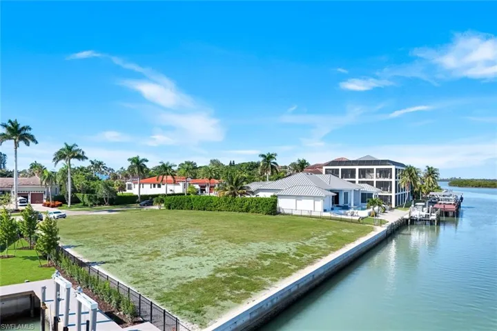 Large .54 acre lot with new seawall, ideal for building your dream home in the prestigious Estates section of Marco Island