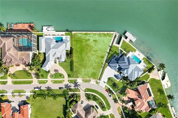 Large .54 acre lot with new seawall, ideal for building your dream home in the prestigious Estates section of Marco Island