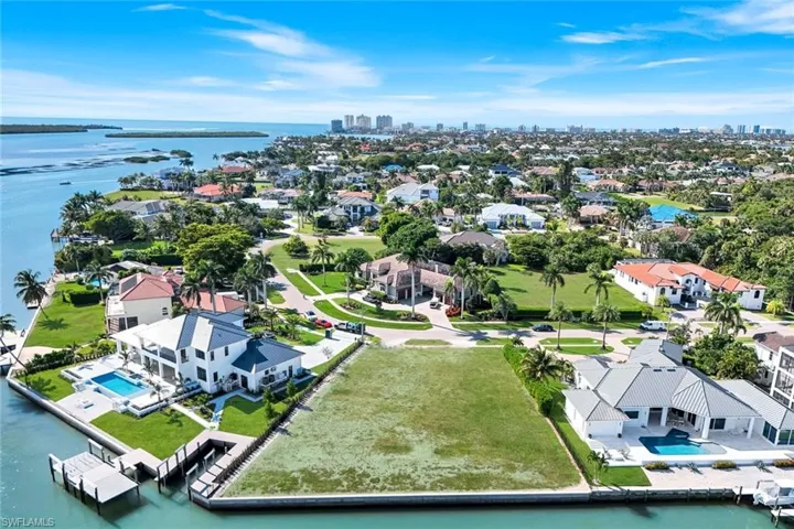Large .54 acre lot with new seawall, ideal for building your dream home in the prestigious Estates section of Marco Island
