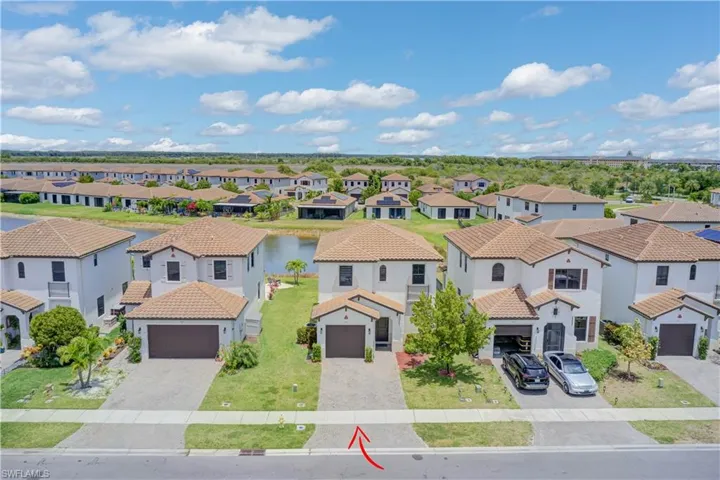 Aerial view of residential area featuring a large body of water