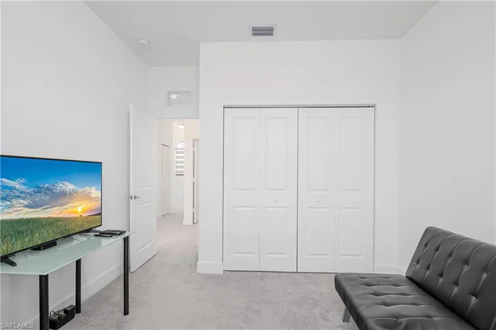 Living area featuring light carpet