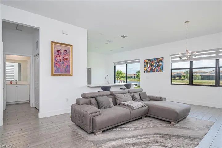 Living area featuring wood finish floors and a chandelier