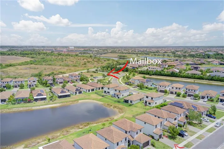 Aerial perspective of suburban area with a nearby body of water