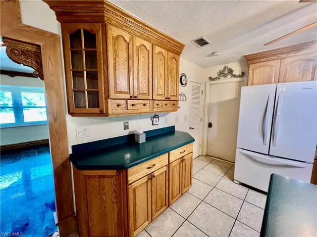 Kitchen featuring a coffee bar with extra countertops and cabinets.