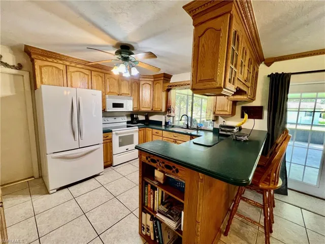 Kitchen featuring a breakfast bar, a sink, and appliances.