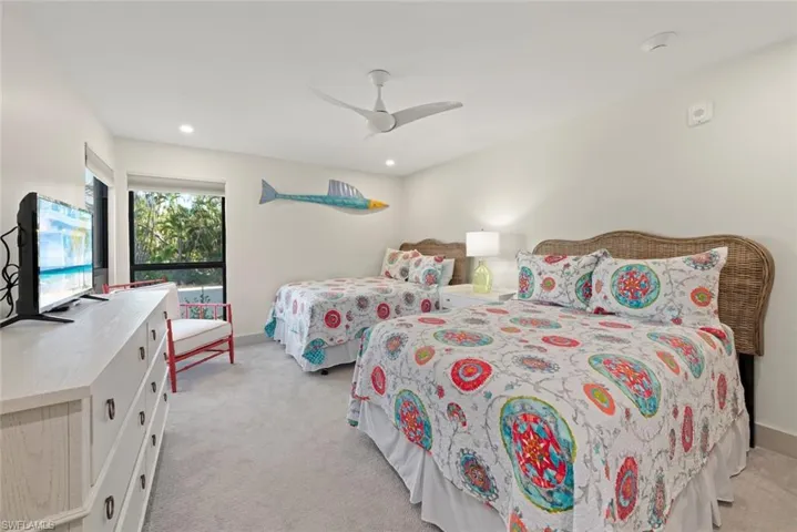 Bedroom featuring light carpet, a ceiling fan, and recessed lighting
