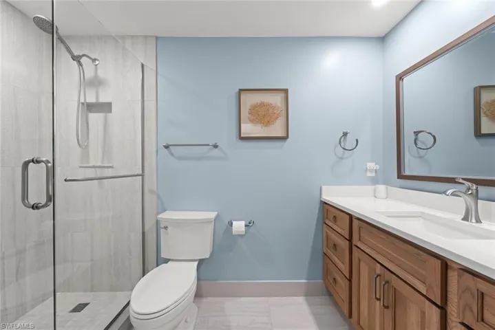 Bathroom with vanity and a shower stall