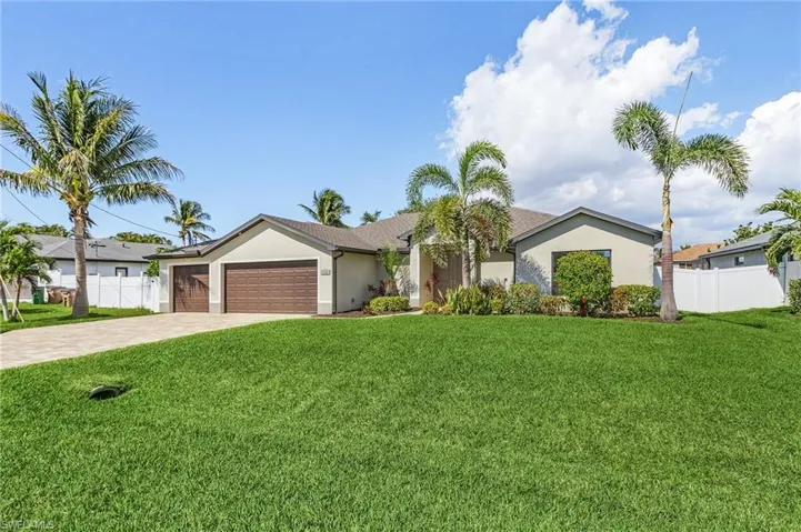 Single story home featuring a front yard and a garage