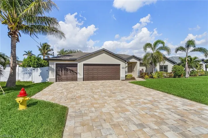 View of front of home with a front lawn and a garage