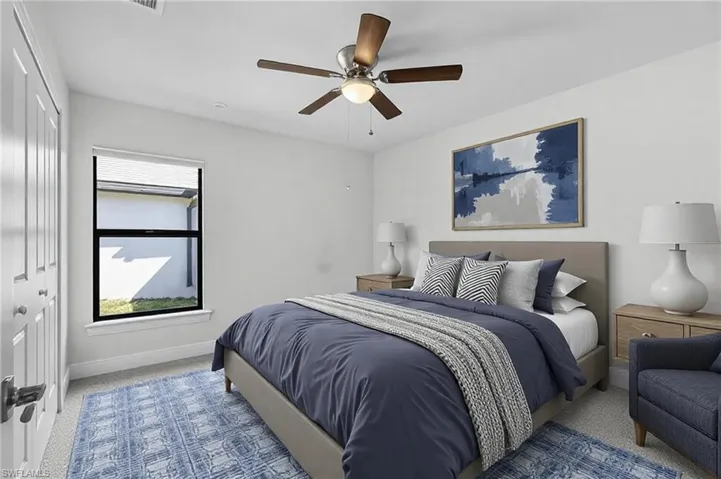 Carpeted bedroom with a closet and ceiling fan