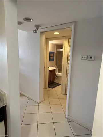 Corridor with light tile patterned flooring
