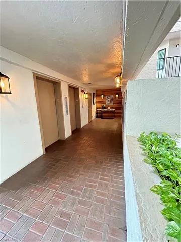 Hallway featuring a textured ceiling