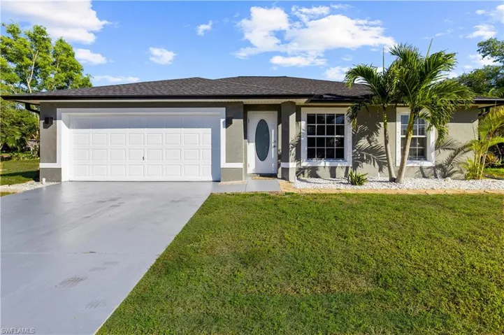 Ranch-style house with a garage and a front yard