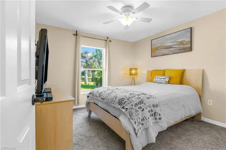 Bedroom with ceiling fan and carpet
