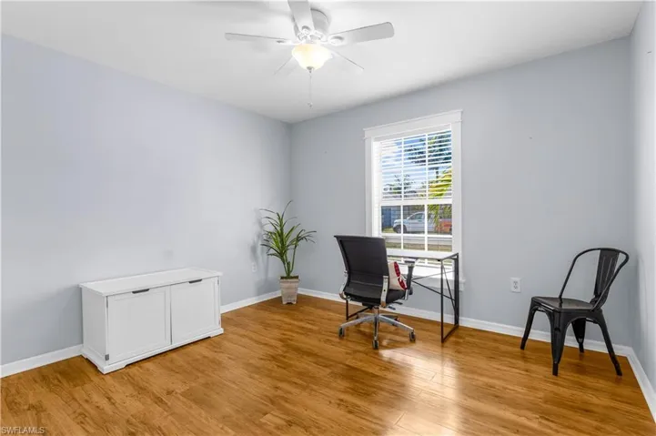 Office area featuring ceiling fan and light wood-type flooring