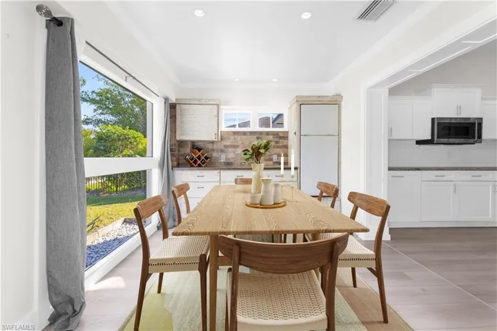 Dining room featuring light hardwood / wood-style floors and ornamental molding