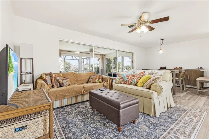 Great room with sliders open to the Sun Room and kitchen