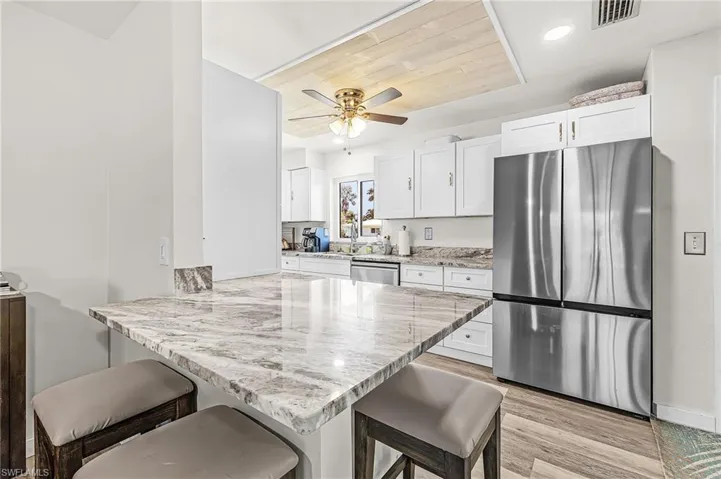 Island and breakfast bar and great custom ceiling