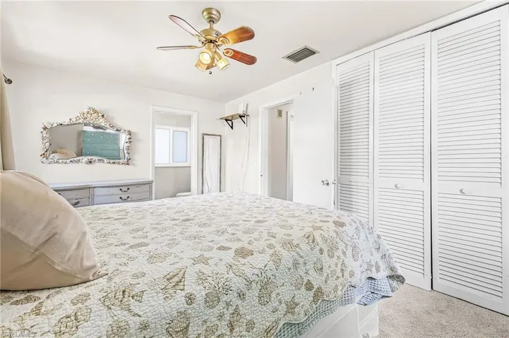Primary bedroom with walk in shower in bath and double closets