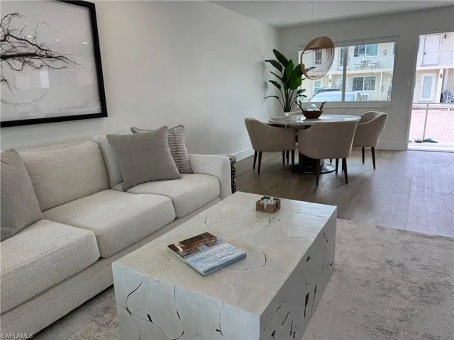 Living room with light wood-style flooring and baseboards