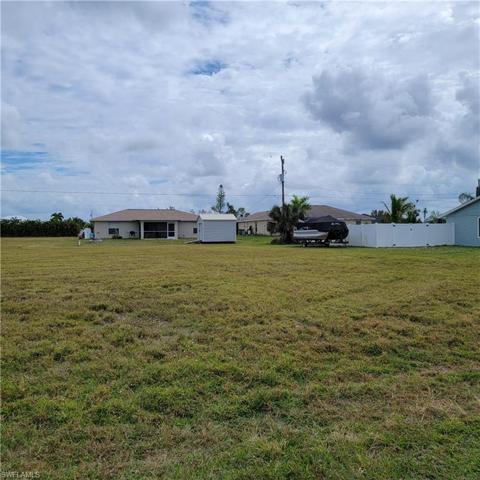 Looking at the lot but a little more to the Right at the house/yard next door
