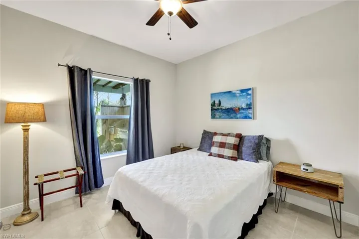 Tiled bedroom with ceiling fan
