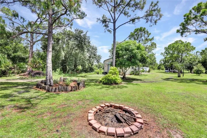View of yard with a fire pit