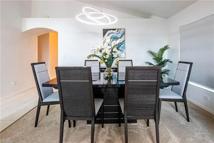 Dining area with an inviting chandelier and light carpet