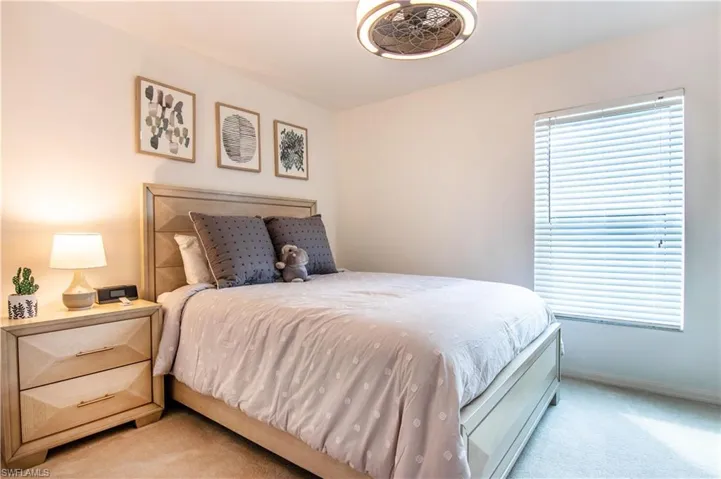 Bedroom featuring light carpet