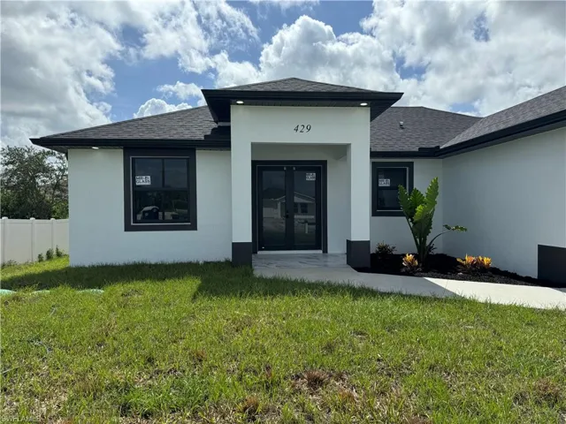 Back of property with a yard