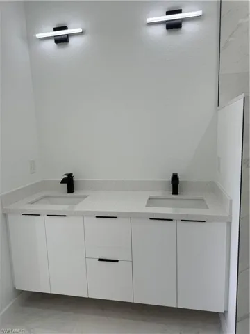 Bathroom featuring tile flooring and sink