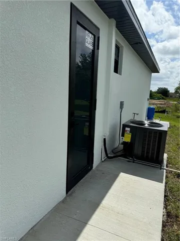 Entrance to property with central AC unit