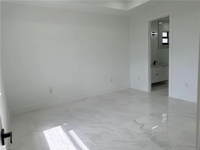 Unfurnished room featuring light tile floors