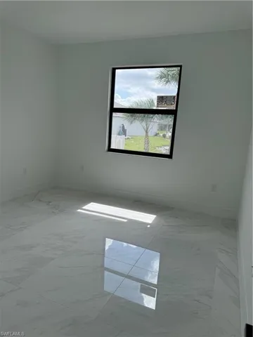 Unfurnished room featuring tile floors