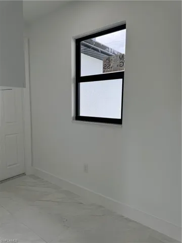 Empty room with light tile floors