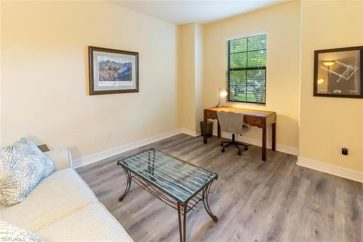 Home office with wood finished floors and baseboards