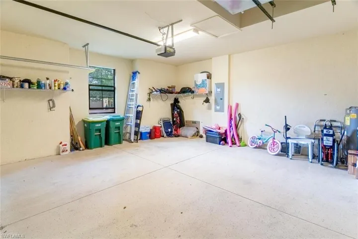 Garage with electric panel and a garage door opener
