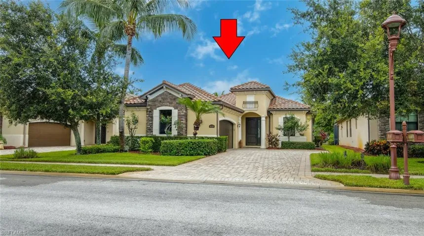 Mediterranean / spanish-style home with stucco siding, an attached garage, a tile roof, driveway, and a front yard