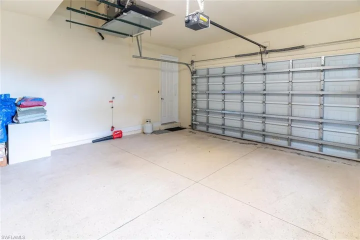 Garage with a garage door opener and baseboards