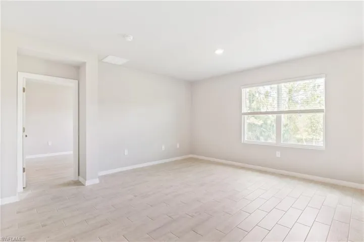 Spare room with light wood-style floors and recessed lighting