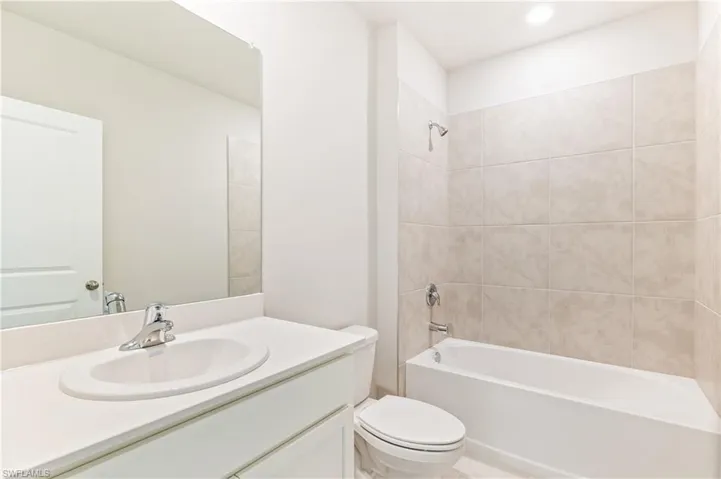Full bathroom with vanity and washtub / shower combination