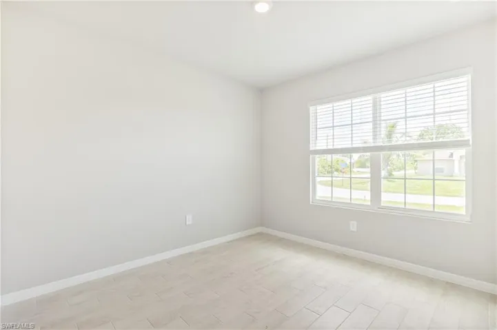 Spare room with light wood-type flooring and recessed lighting
