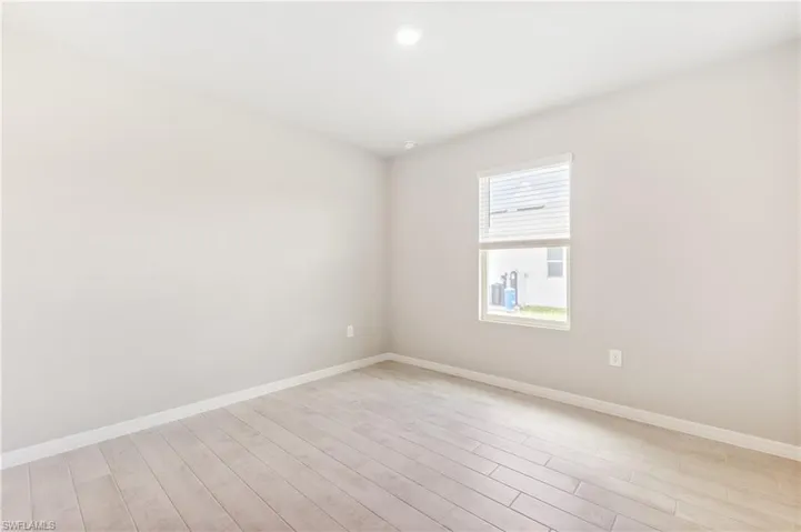 Spare room with light wood finished floors and baseboards