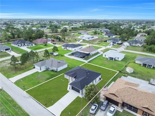 Aerial view of a residential neighborhood with single-story homes, featuring established streets and green landscaping