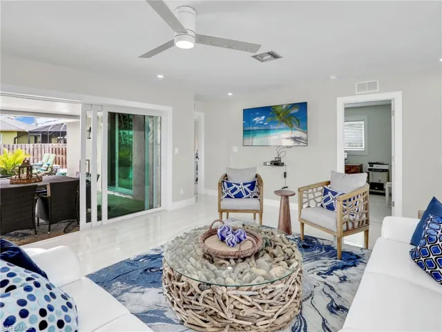 Living room with ceiling fan and a healthy amount of sunlight