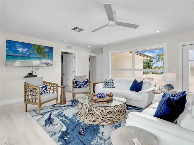 Living room featuring ceiling fan and hardwood / wood-style floors