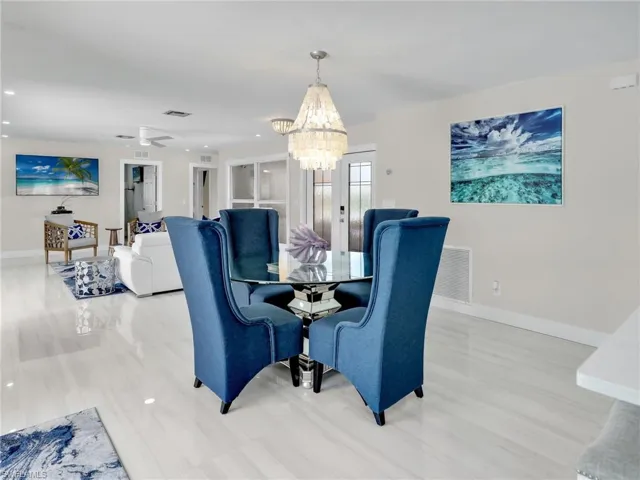 Dining area featuring ceiling fan with notable chandelier